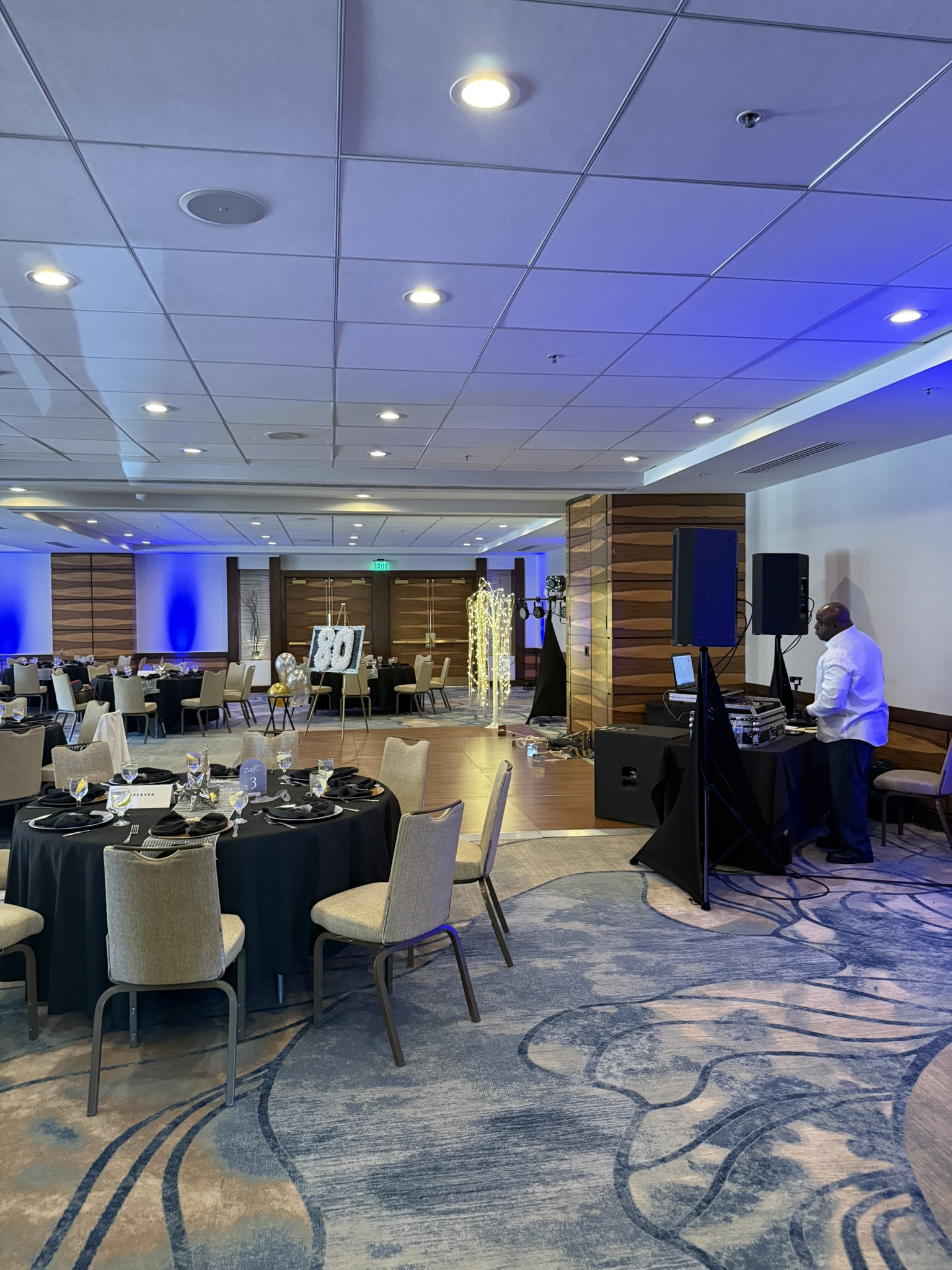 Corporate awards gala at hotel ballroom with blue uplighting